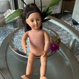 Our Generation Doll with dark brown hair and blue eyes.